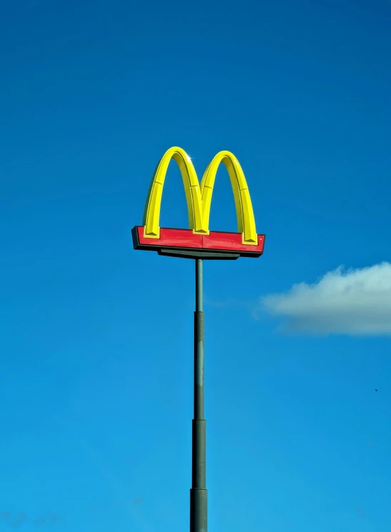 a sign that reads mcdonald's sitting atop a pole