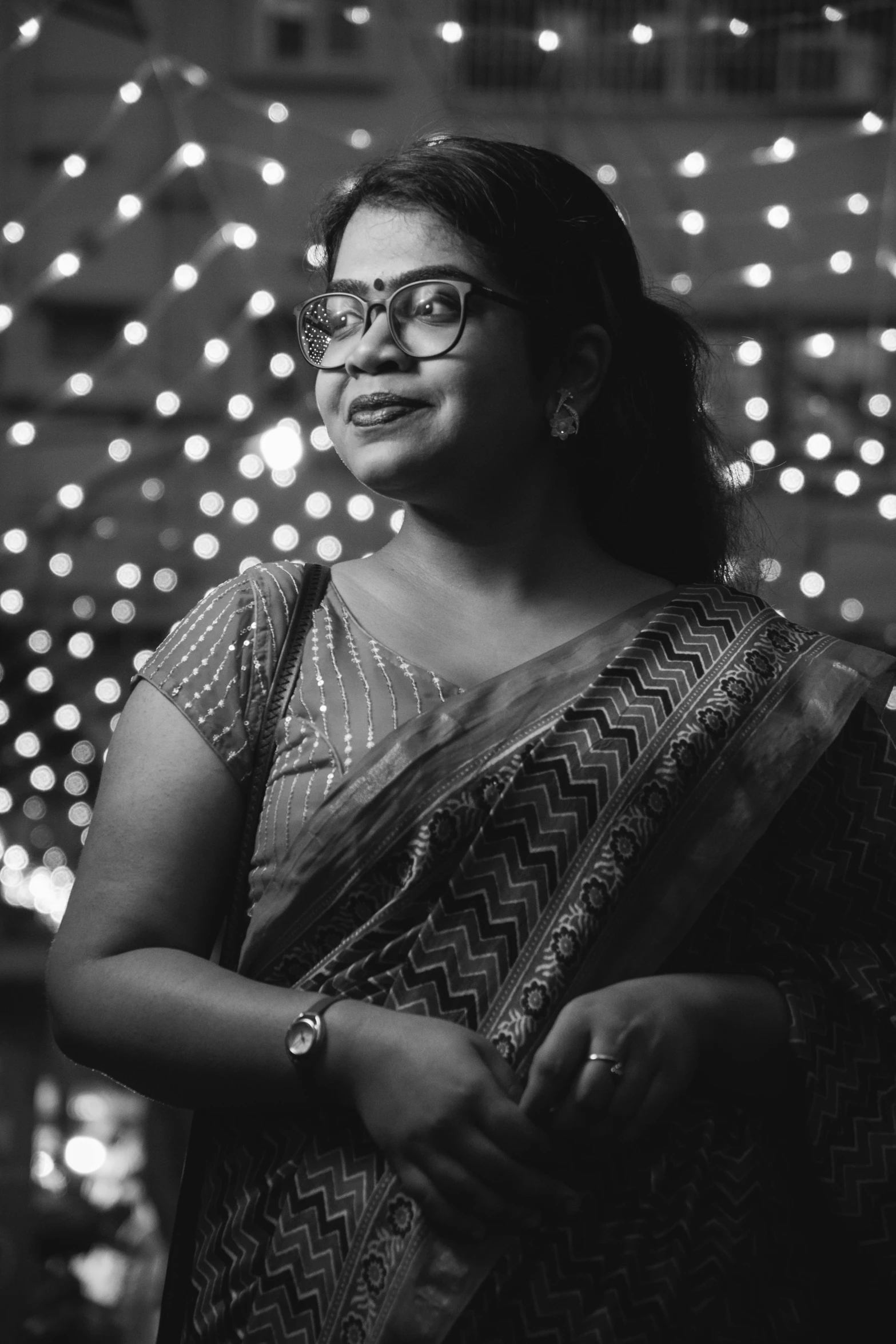 a woman in a sari holding onto a scarf