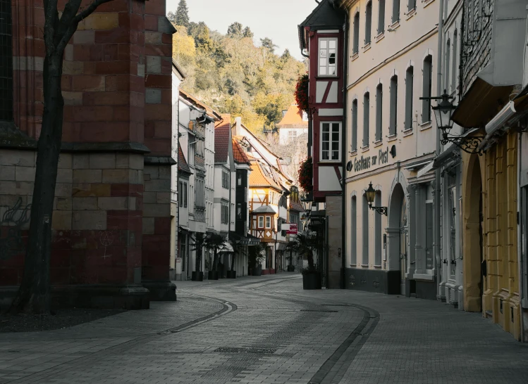 a narrow street surrounded by houses in the middle of it