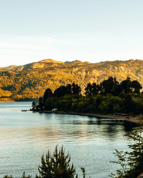 a beautiful mountain is in the distance over a calm lake