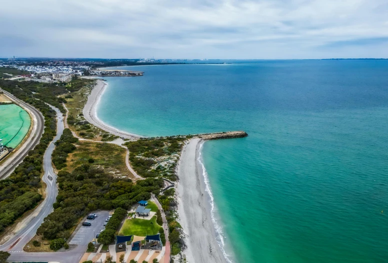 the shoreline and water surrounding a town by a beach