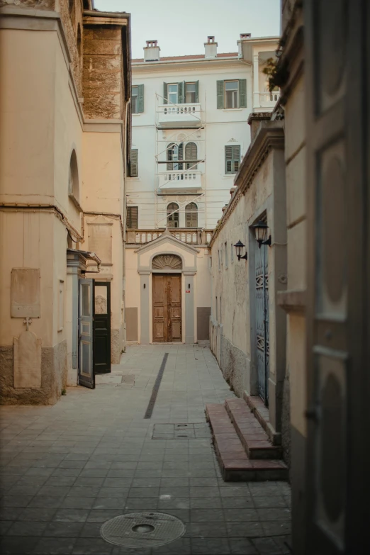 an empty courtyard and a stone building in an old, historic city