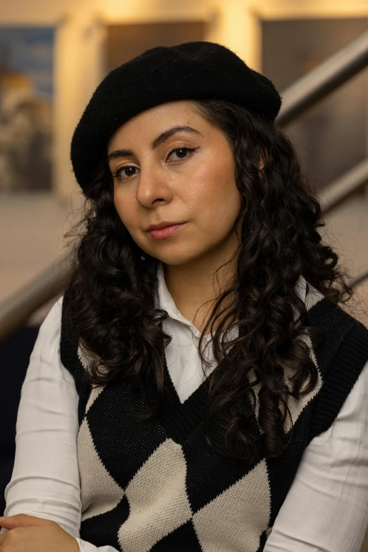 a woman wearing a hat and a vest