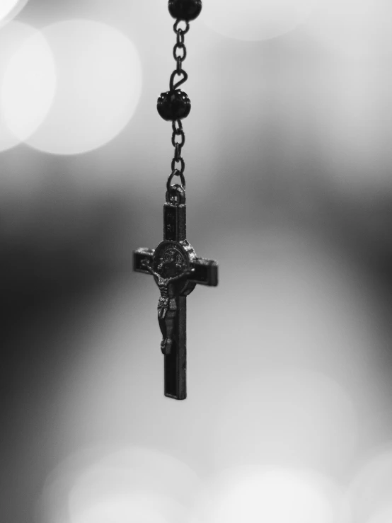 the cross is attached to the metal chain