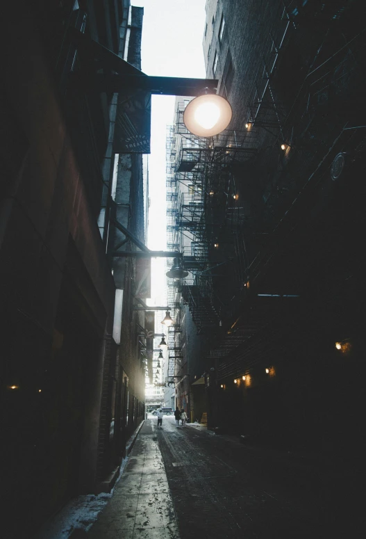 looking down an alleyway in an industrial area at dusk