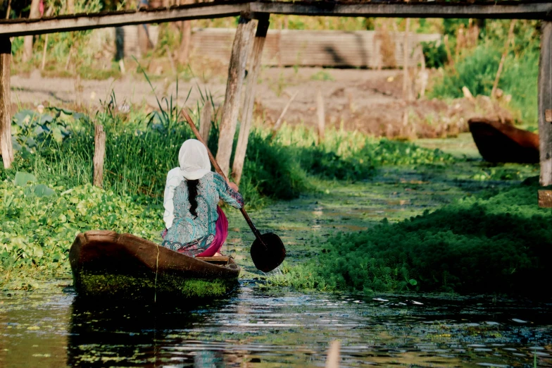 a woman in a canoe with a paddle