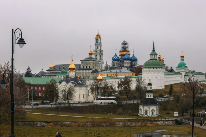 an ancient building with green roofs in a park