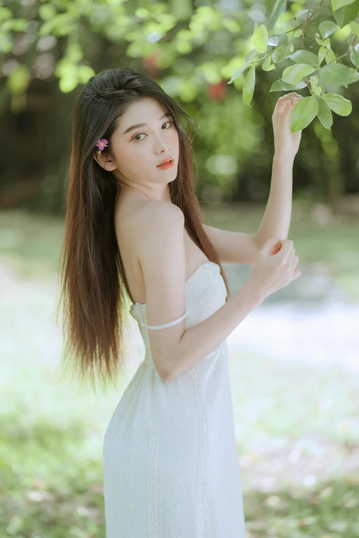 a woman is holding some leaves in the air