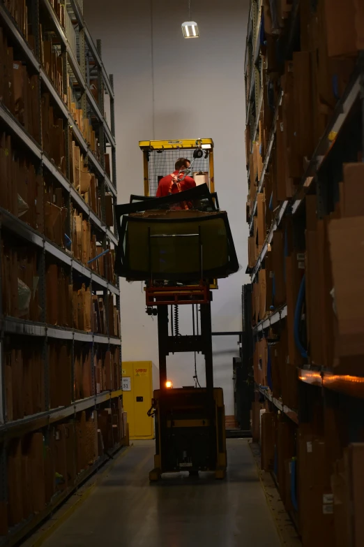 a small machine moving through an industrial warehouse