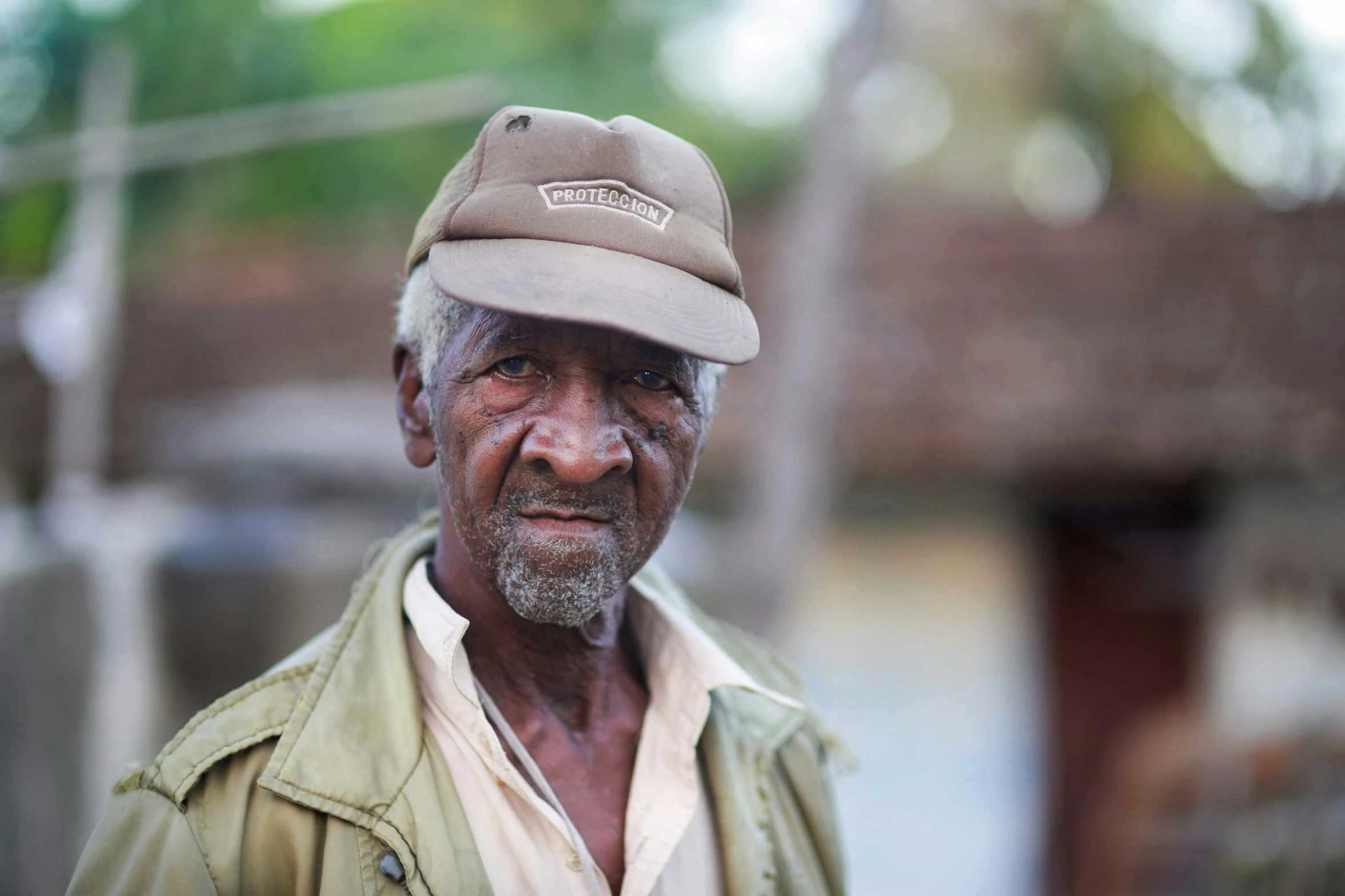 a man with a cap is standing outside