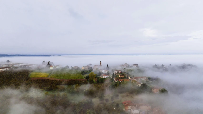 a view from above looking down at an island and some fog