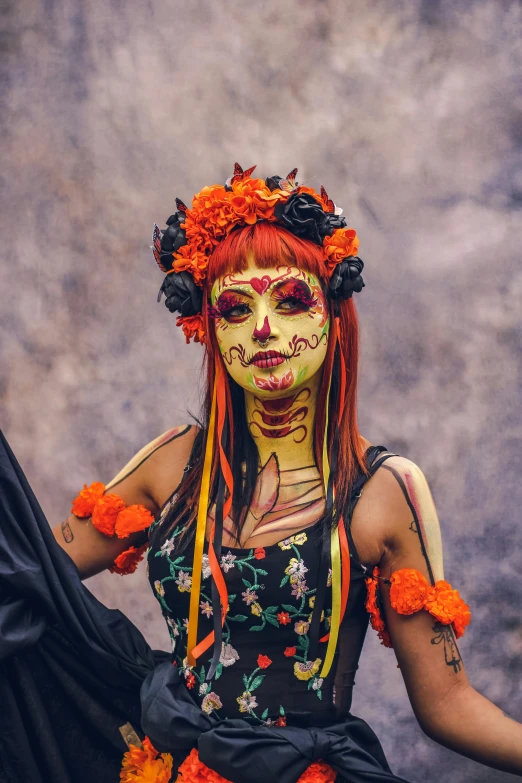 woman with painted face and body in orange flowers