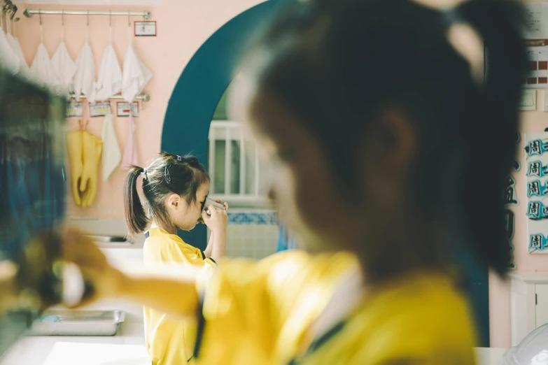 a person getting their hair done in front of a mirror