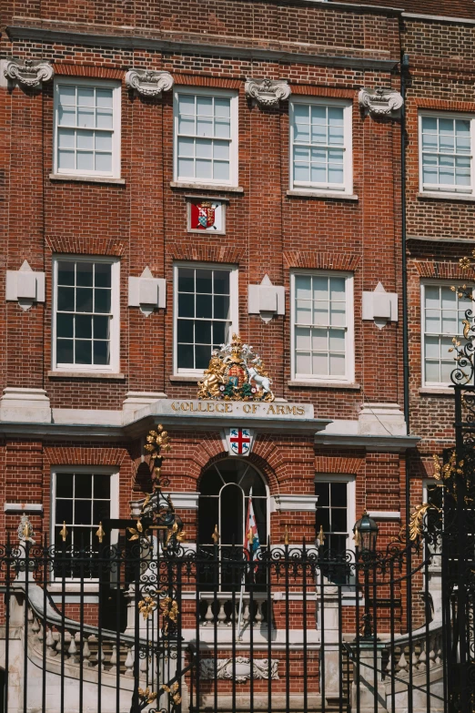 the gate is near to the large red brick building