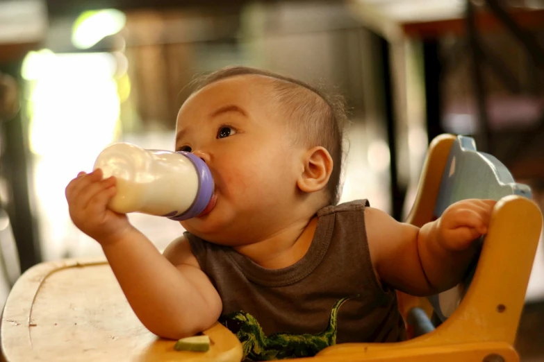 a baby with a sippy cup in his hand