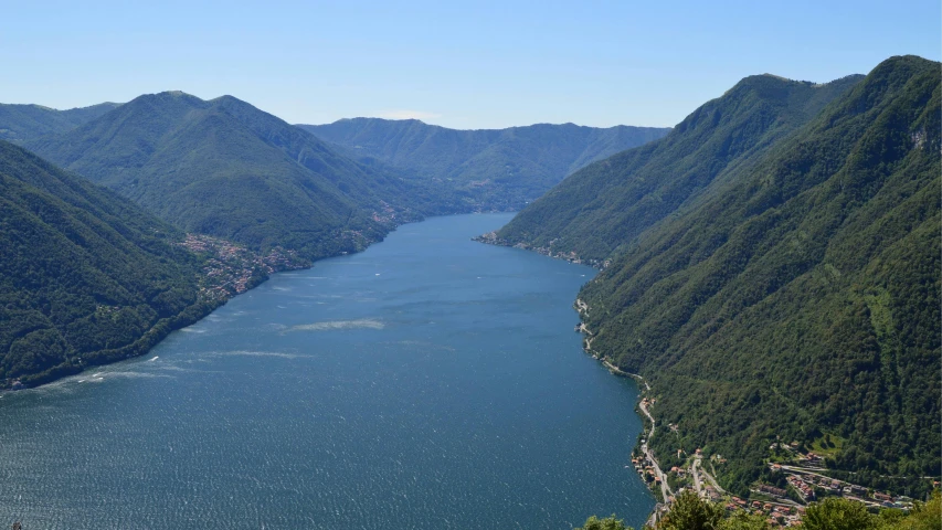 a lake with mountains and a village on the side