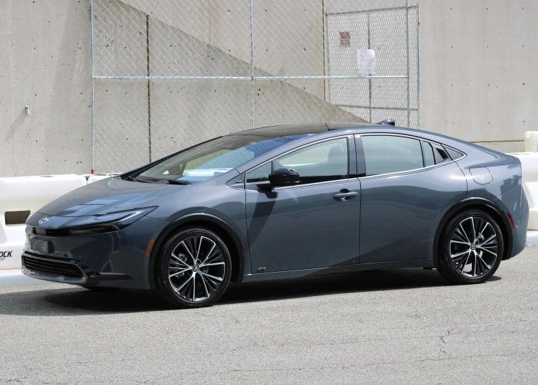 the front of a gray hydrogen car driving down the road