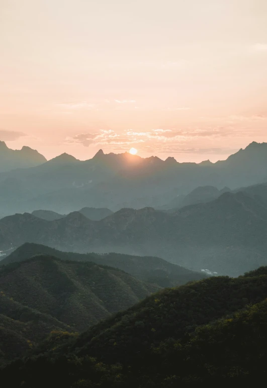 the sunset shining in over the mountain tops