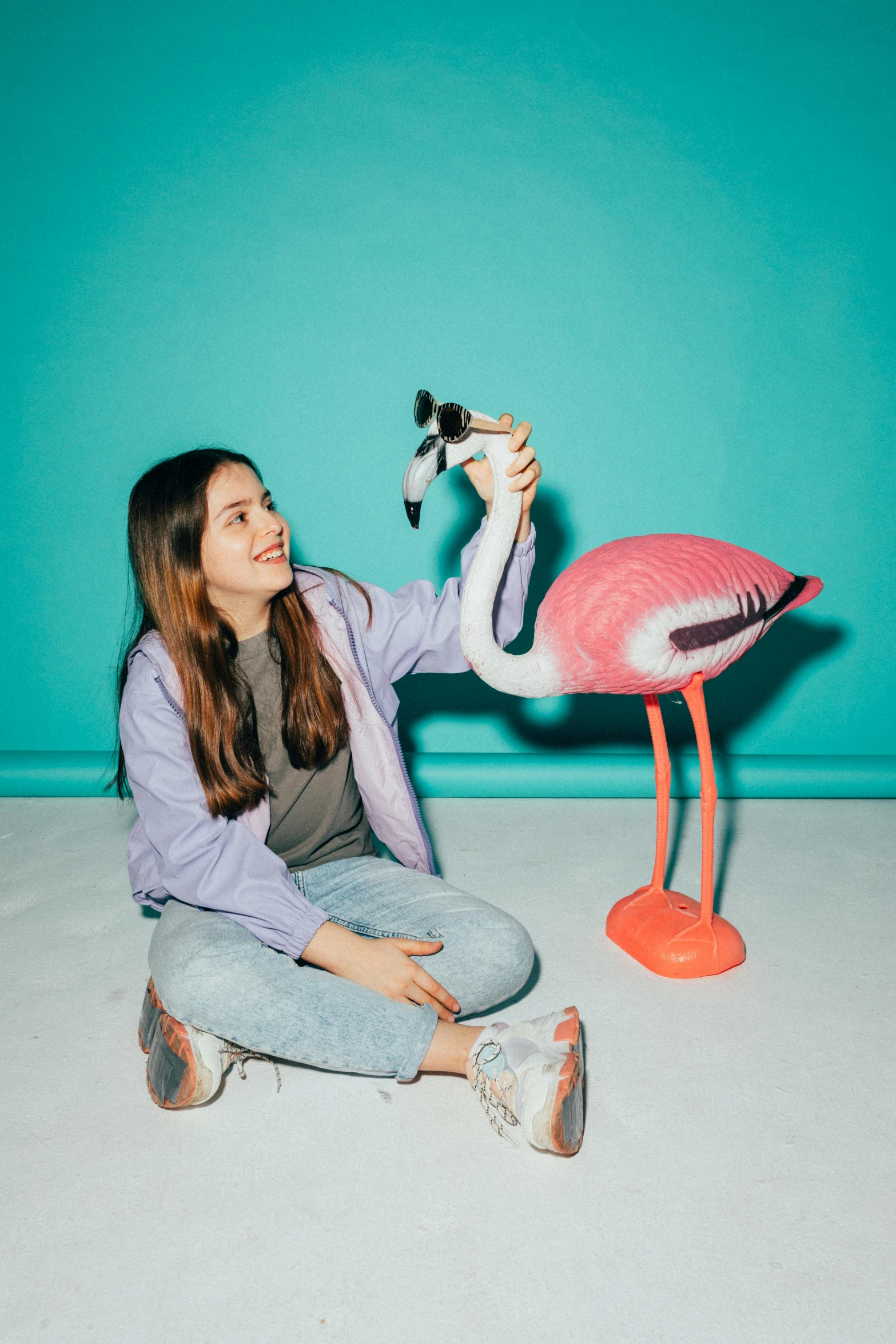 woman looking at flamingo on toy bird