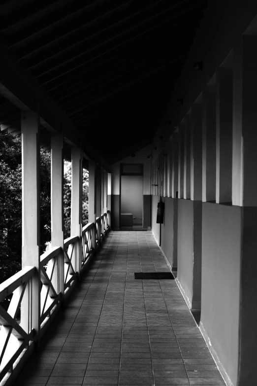 some kind of long hallway with benches in black and white