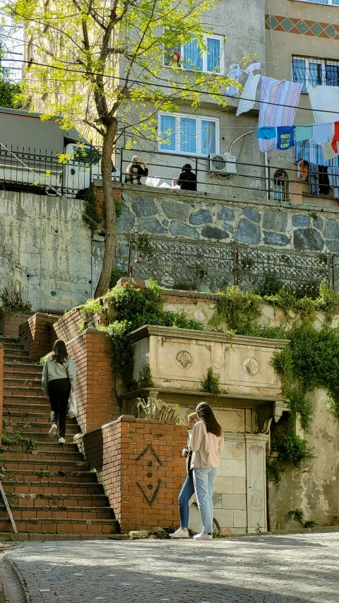 a girl is on the street looking down the stairs