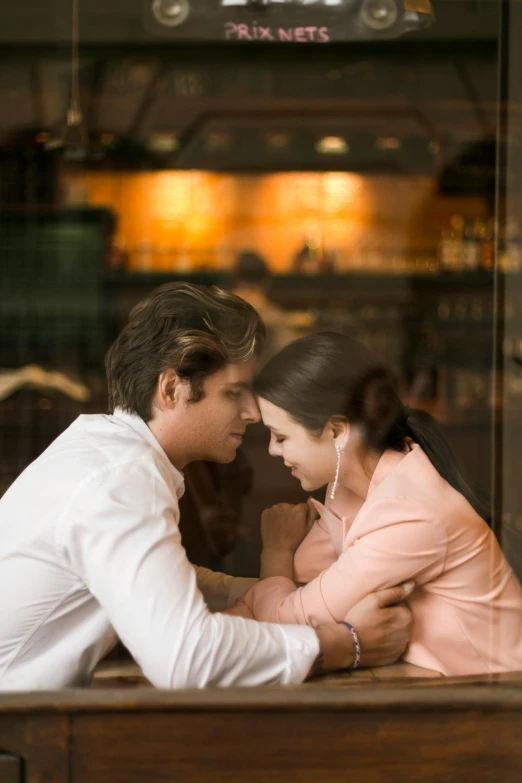 a young couple sitting together at a restaurant