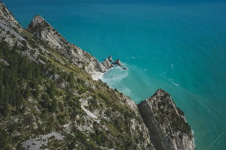 a kite surfer is gliding down the side of a steep mountain