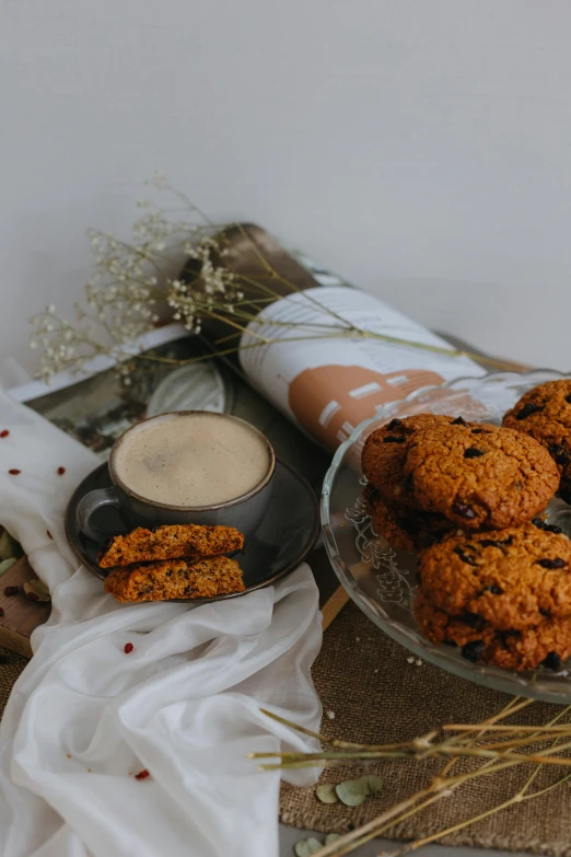 an assortment of cookies with a coffee mug on the table