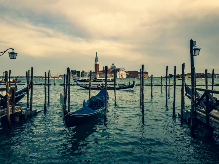 the water has several poles that connect the harbor with many boats