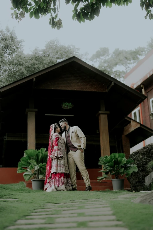 a bride and groom standing by a gazebo