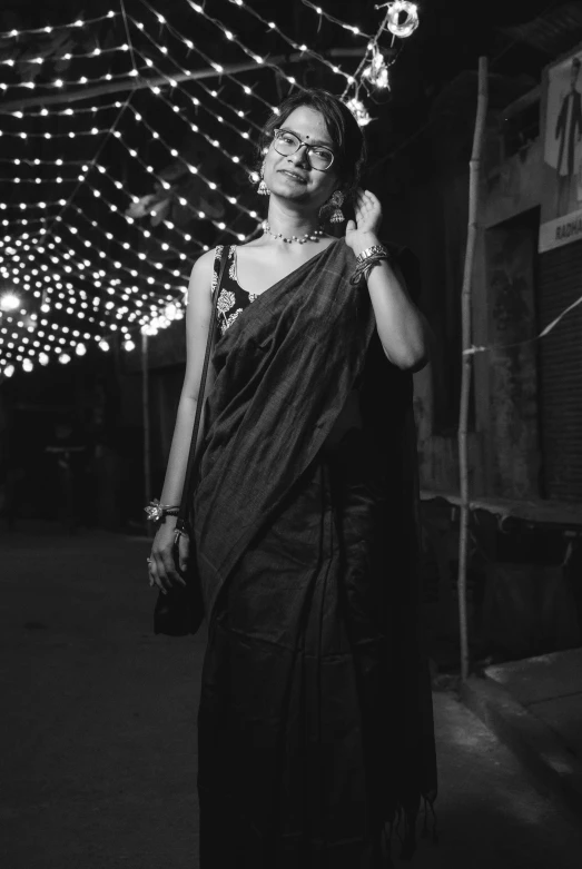 woman with lights around her head on a street at night