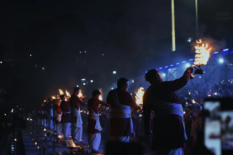 people are doing different things with torches in hand