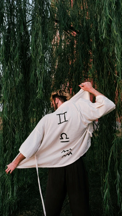 a man balancing himself on his hands with the words i, and the trees in front