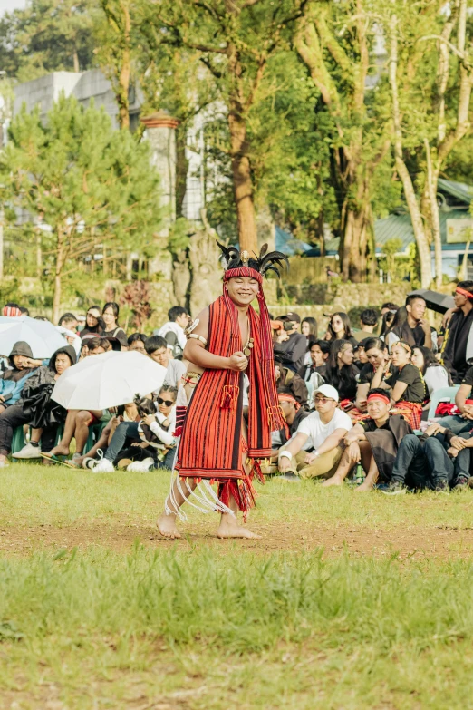 an indian woman is performing on the ground