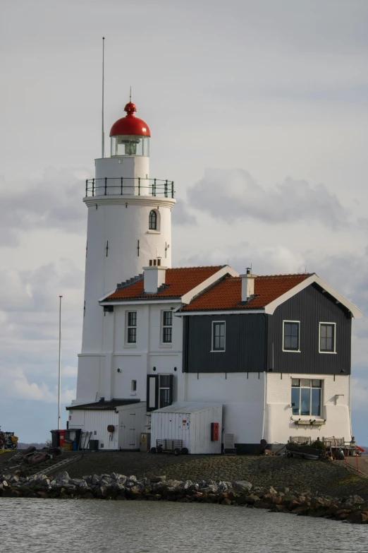 a big lighthouse on a rocky island with two towers