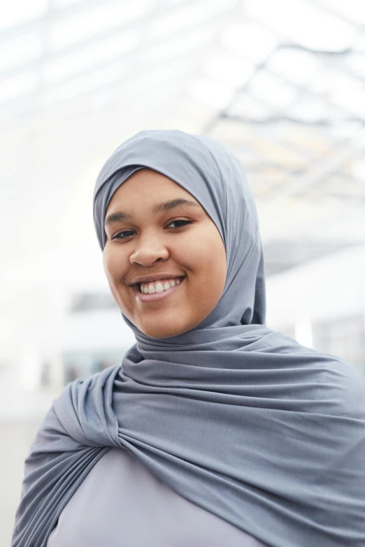 an image of a woman smiling wearing a headscarf