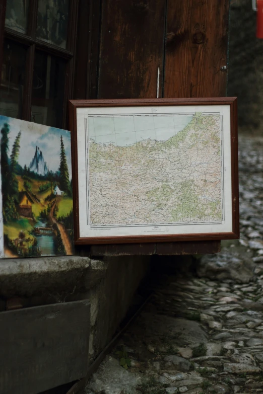 a framed map and another piece of artwork