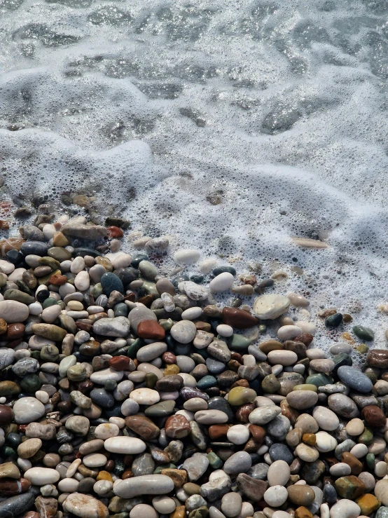 small waves crash onto rocks and a beach