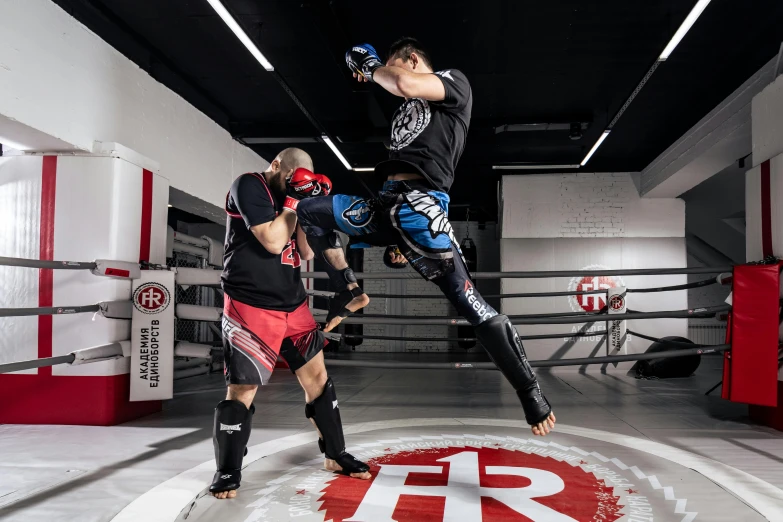 two people in a ring practicing kickbox boxing