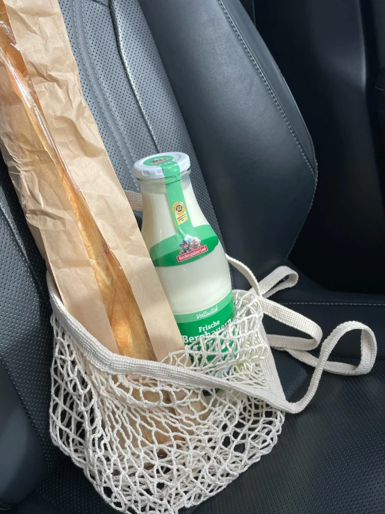 a bottle of milk in the backseat of a car