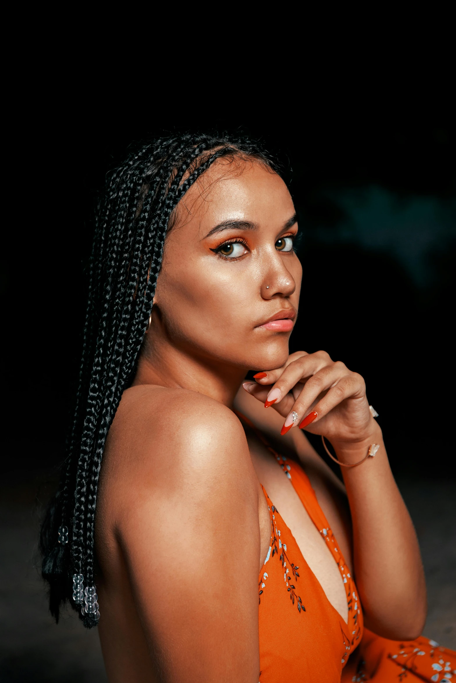 a young woman with a id in an orange dress