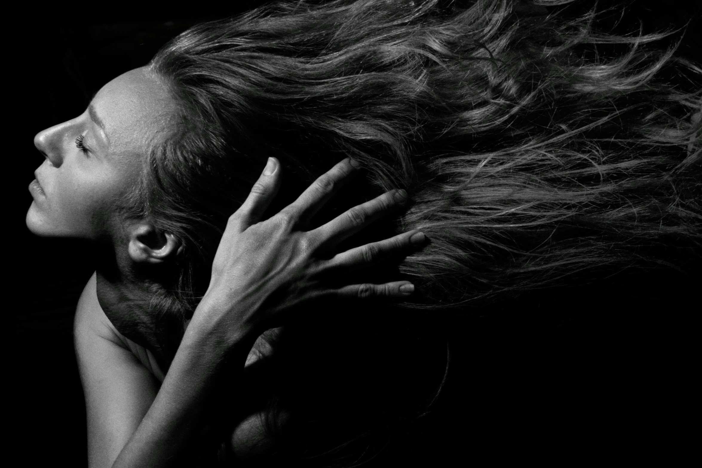 a woman with her hair flying in the air