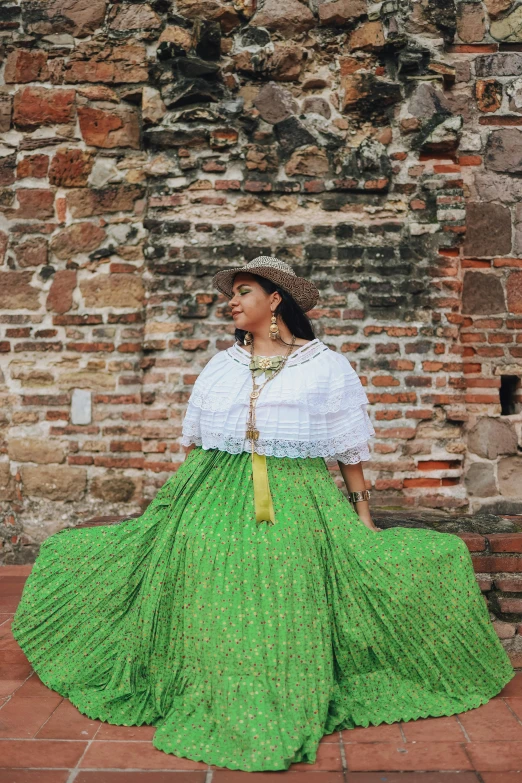 a woman in a green skirt and white blouse