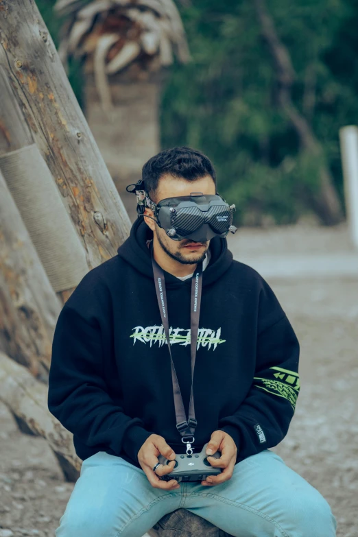 the man wearing an eye mask is holding a camera