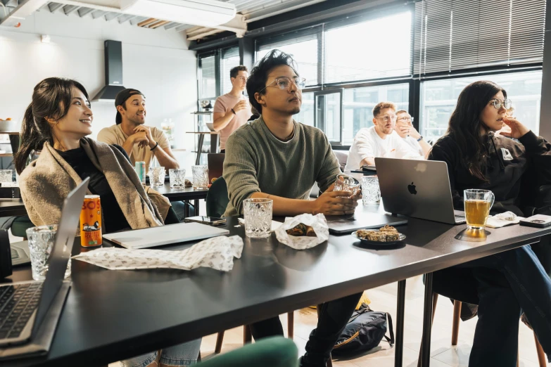 several people sitting at a table in an office