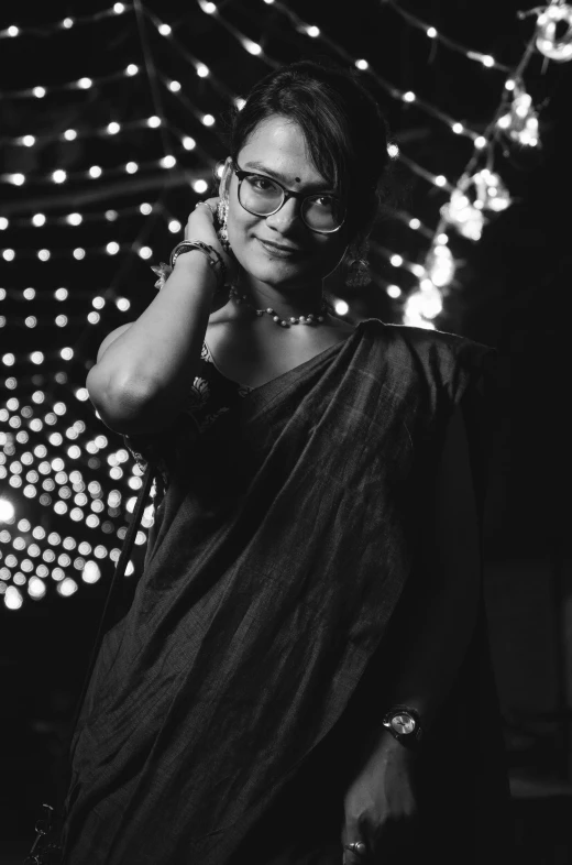 a woman with glasses posing in a black and white po