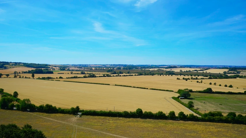 a farm is next to the road in the middle of the field