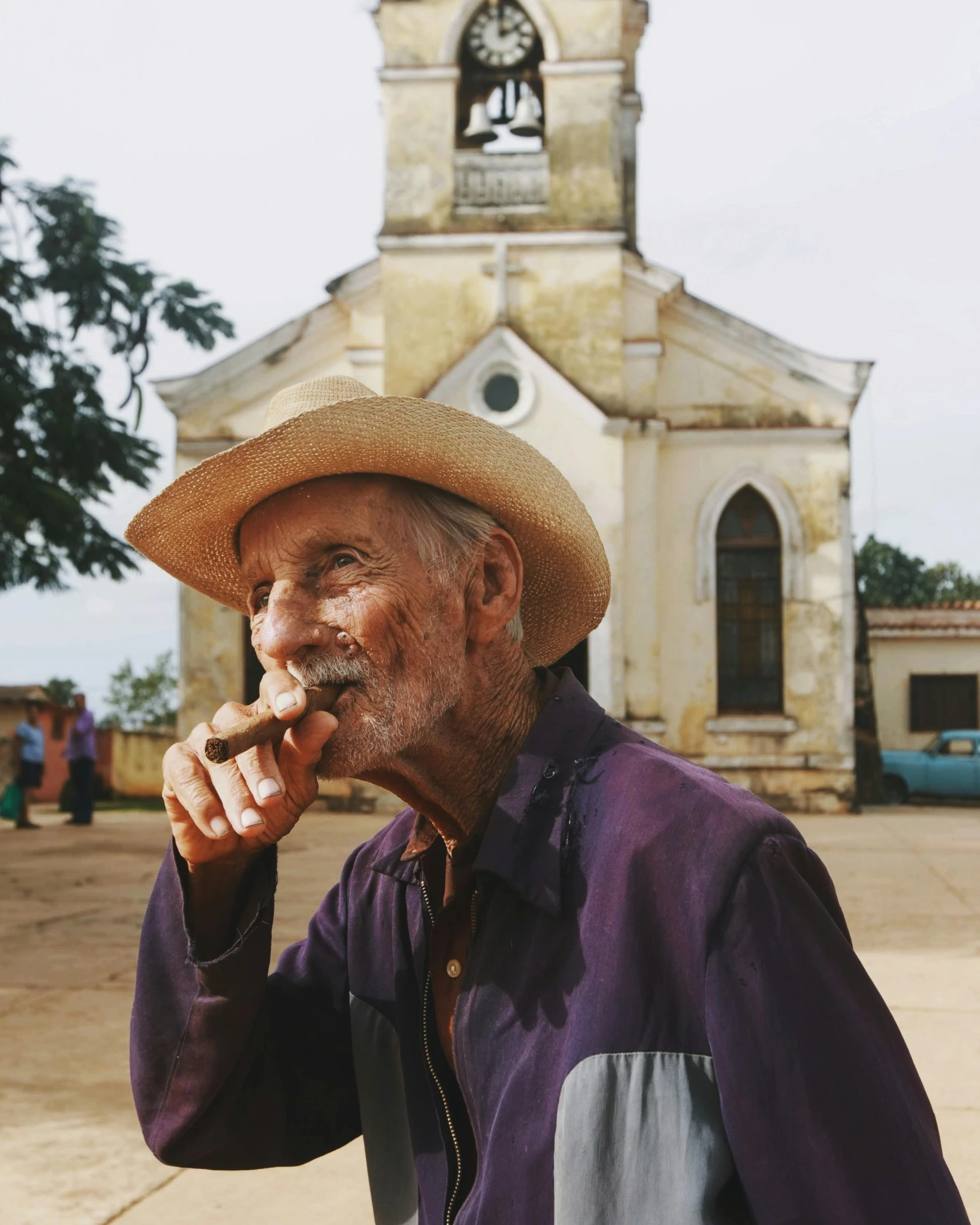 a man wearing a cowboy hat with food in his mouth