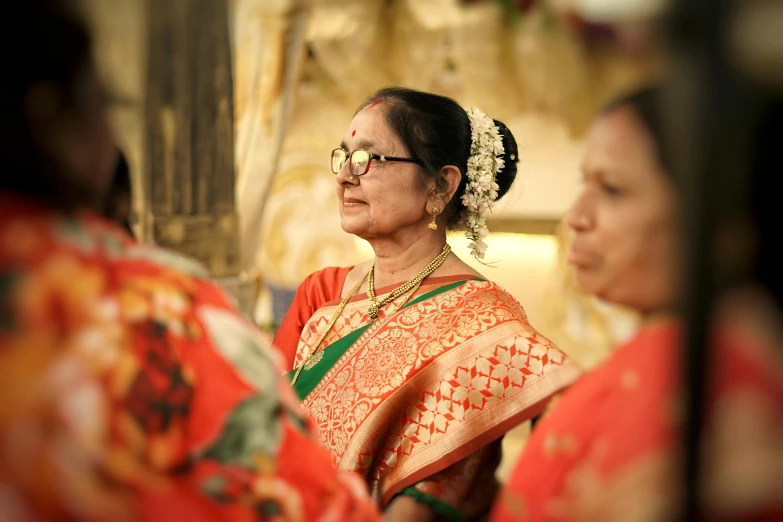 the indian woman is wearing a red and white dress