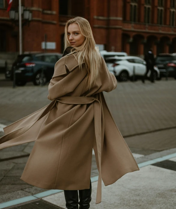 a woman standing on the street in the middle of a city